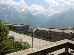 Une vue sur une montagne avec des bâtiments au premier plan.