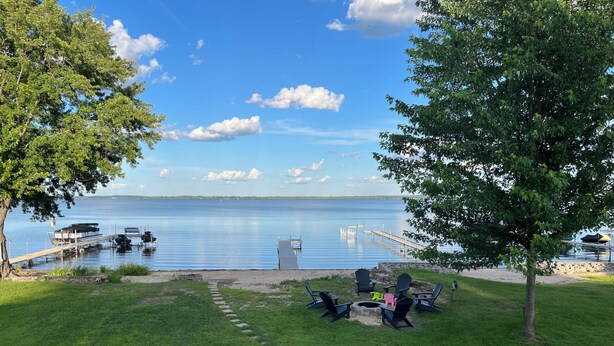 A lakeside patio with outdoor seating, a dock, and a clear view of the water. - Inviting Lakefront Escape with Modern Comforts & High‑Speed Fiber (Edgerton)