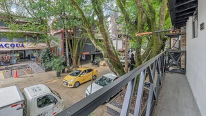 Straßenansicht mit einem Gebäude mit der Aufschrift 'ACQUA HOTEL', einem gelben Taxi und einem weißen Lieferwagen.