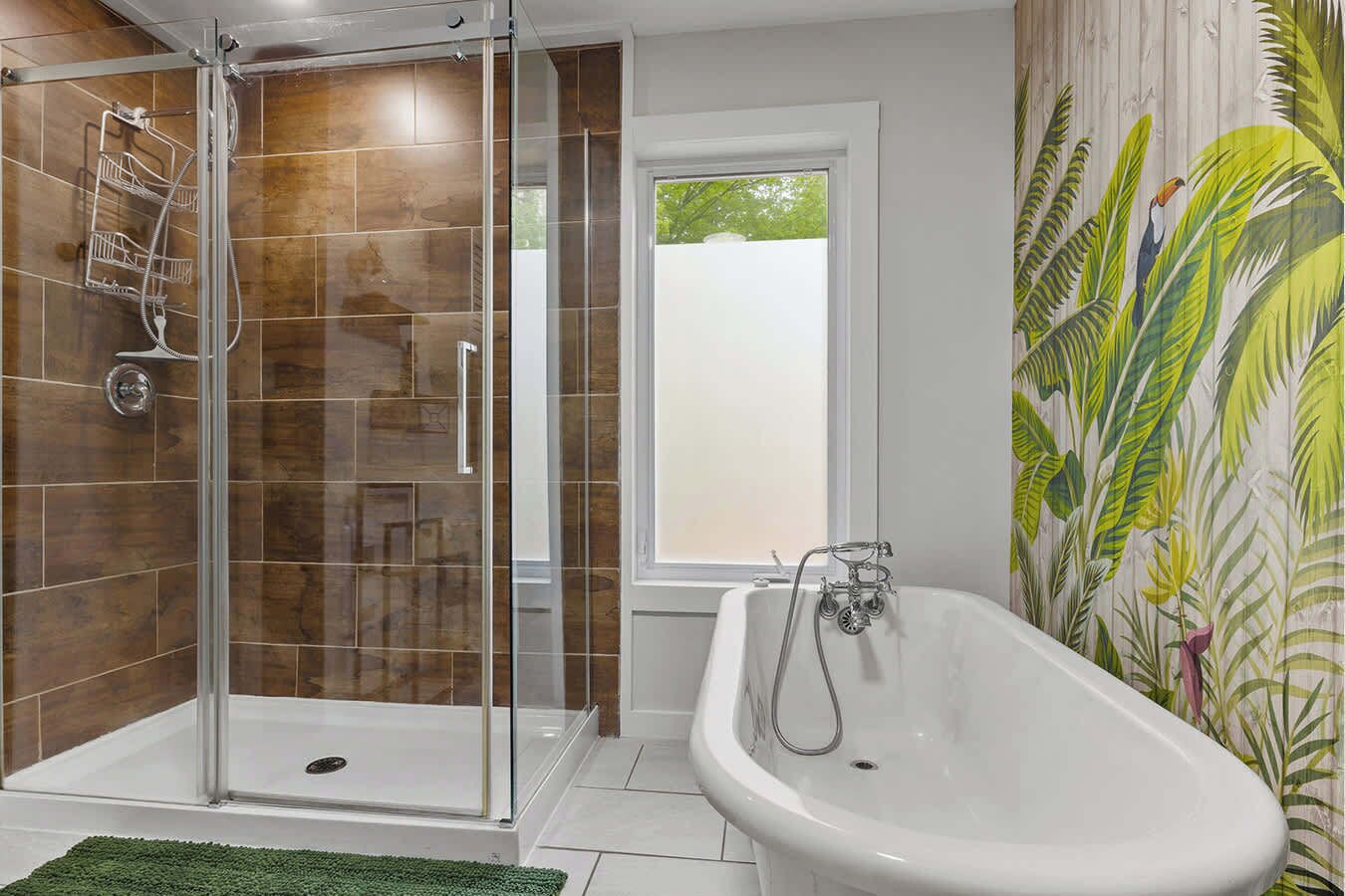 A bathroom with a glass-enclosed shower, a freestanding bathtub, and a window.