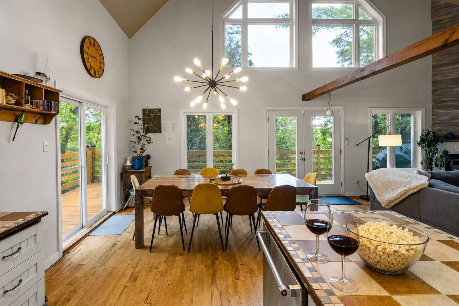 A spacious dining area with a wooden table, chairs, and a large window providing a view of the outdoors.
