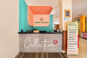 A hotel reception desk with a sign reading 'HOTEL FIDUCIA' and a 'Collection' sign below it. - Townhouse Oak New Fiducia Kaji 2 (Jakarta)