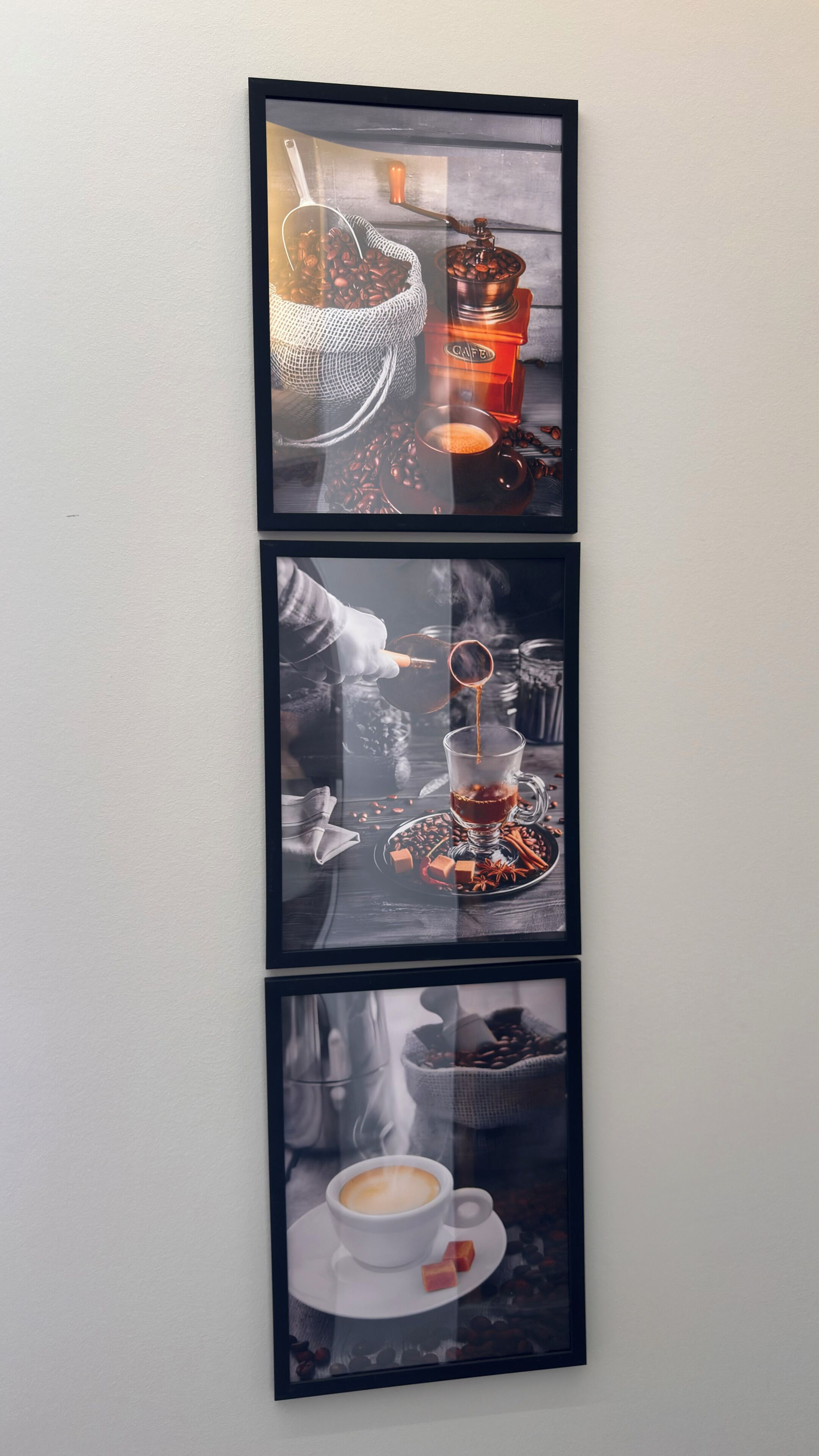 A wall-mounted triptych of coffee-related scenes.