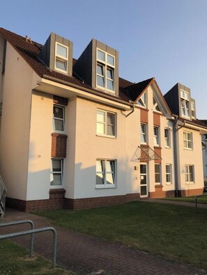 A multi-story residential building with a flat roof, large windows, and a brick foundation. - Large Baltic Sea Nest (Boltenhagen)