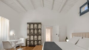 A bedroom with a bed, bedside table, and a decorative panel. - Carla, elegant and romantic studio suite on the 2nd floor in the city of Noto (NOTO)