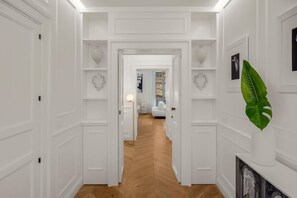 A hallway with white walls, wooden flooring, and decorative heart-shaped wall art. - Christine, elegant 1st floor suite with balcony and views of the city's baroque (NOTO)