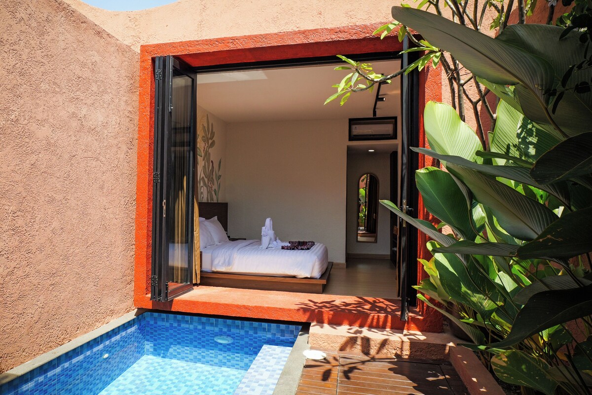 A private pool area with a bedroom visible through an open door.