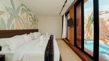 A hotel room with a bed, a TV, and a view of a swimming pool.