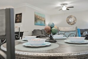A dining table with decorative bowls and a central bowl with colorful eggs. - Modern Dallas Retreat ~ Spacious 3BR + 2.5BA (Dallas)