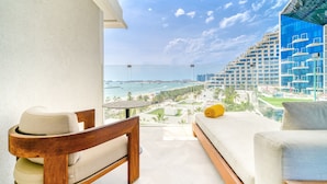 A balcony with a view of a beach and high-rise buildings. - FIVE Palm Jumeirah: 4BR Penthouse w/ Private Pool (Dubai)