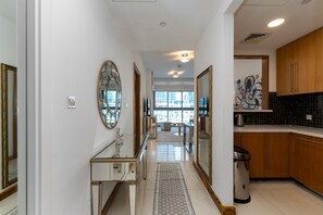 Eine moderne Küche mit Holzausstattung, einer Edelstahl-Spüle und einem großen Fenster mit Blick auf die Stadt.