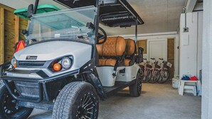 A white utility vehicle with a roof rack and a spare tire mounted on the back. - Sandcastle | Steps to Beach | Pool | Golf Cart (Anna Maria)