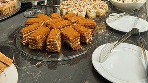 A buffet with various desserts and fruits. - Safia Plaza Hotel (Bukhara)