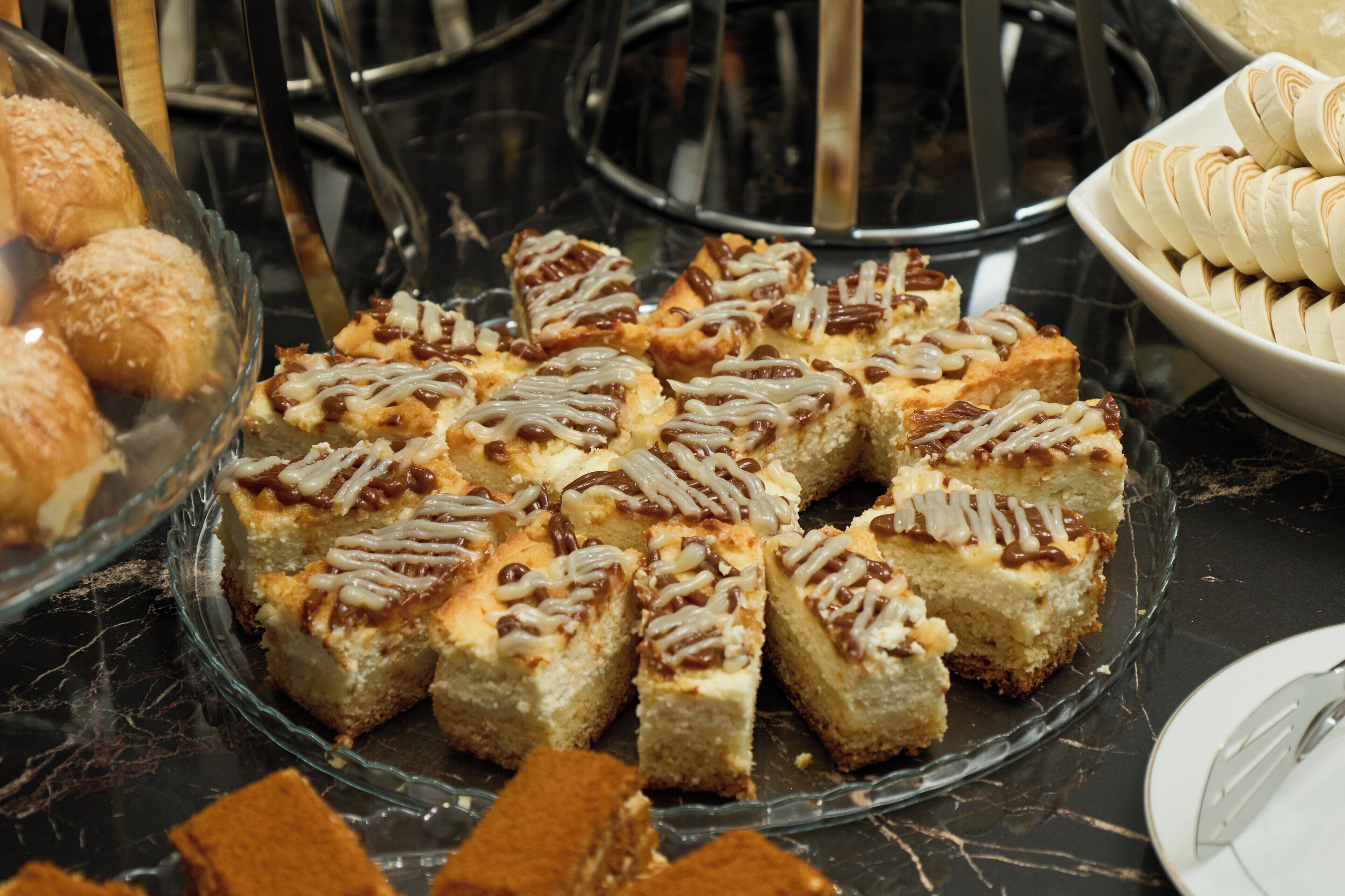 A dessert display with various baked goods.