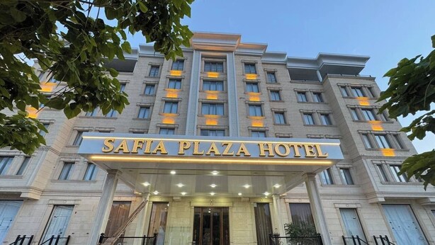 A multi-story building with a sign reading 'SAFIA PLAZA HOTEL' at the entrance. - Safia Plaza Hotel (Bukhara)