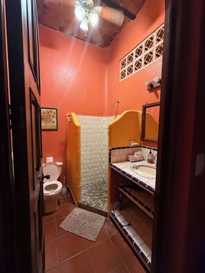 A compact bathroom with a toilet, shower, and sink. - Casa Sorpresa mexican charm by the beach (Sayulita)
