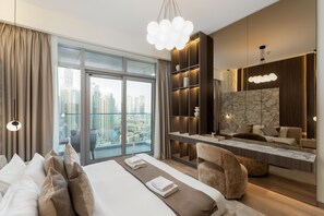 Ein modernes Hotelzimmer mit einem großen Bett, einer Sitzecke, einer Wand mit Marmorverkleidung und Blick auf die Stadt.