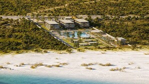 An aerial view of a resort with multiple buildings, a swimming pool, and a beachfront. - Jeriquiá Lagoa Resort - Gav Resorts (Cruz)
