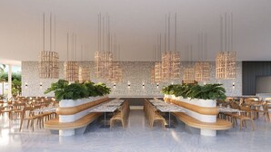 A modern restaurant with a central seating area, high ceiling, and hanging light fixtures. - Jeriquiá Lagoa Resort - Gav Resorts (Cruz)