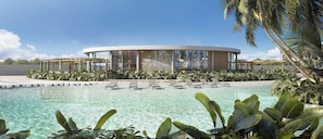 A modern pool area with lounge chairs, a circular building with large windows, and tropical plants.