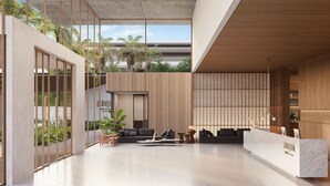 A spacious lobby with a reception desk, seating area, and large windows overlooking greenery. - Jeriquiá Lagoa Resort - Gav Resorts (Cruz)