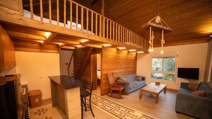 A wooden interior with a kitchen, bar area, seating, and a staircase. - Beel Hills - SOLARA (Mar Mikhael Bnabil)