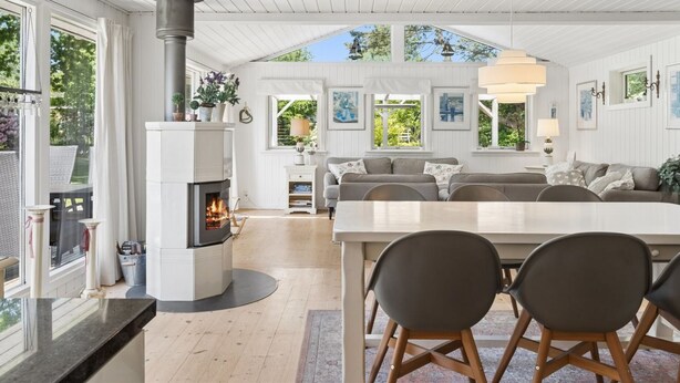 A spacious living area with a fireplace, a large dining table, and a cozy seating arrangement. - "Stig" - 1.1km from the sea by Interhome (Hornbæk)