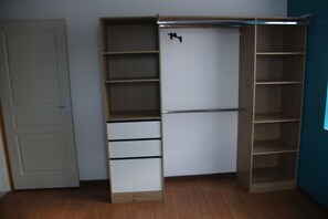 Ein Zimmer mit Kleiderschrank, Tür und Regalelement.