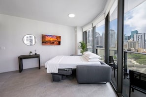 A modern bedroom with a bed, bedside table, and a large window with a city view. - Brand New Apt 1 Bed 4 Guest Bay & Brickell View (Miami)