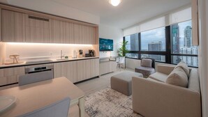 A modern apartment with a kitchen, dining area, and living room with a city view. - FREE Parking • Corner Unit • Bay & Brickell Views (Miami)