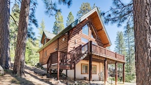 A log cabin with a deck, surrounded by trees. - Cozy Log Cabin, Ping Pong, Firepit, Dog friendly! (Arnold)