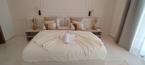 A spacious bedroom with a large bed, two bedside tables, and a neutral color scheme. - Villa de Luxe avec Piscine Privée - Une Oasis d'Exception à Marrakech ". (Marrakesh)