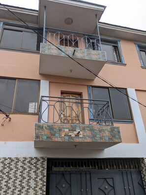 A multi-story building with a balcony, a door, and a window. - Anna Luxury Lodge - Arusha  (Arusha)