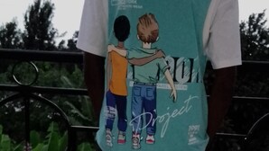 A person wearing a teal and white shirt with a graphic design on the back. - Anna Luxury Lodge - Arusha  (Arusha)