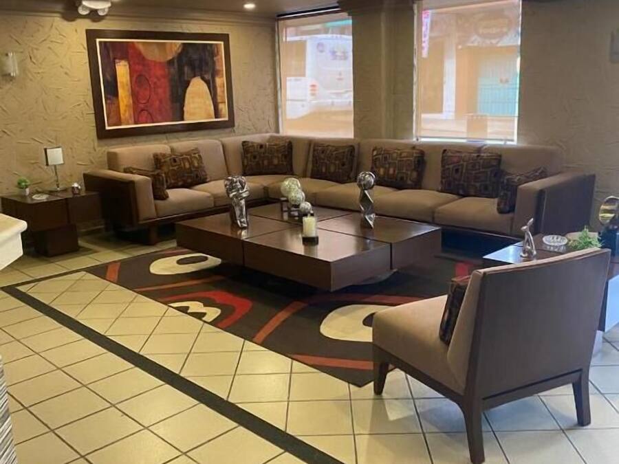 A living room with a sofa set, a coffee table, and a TV.