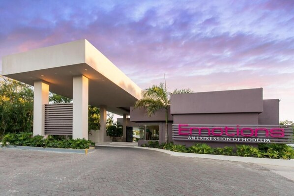 A modern building with a sign reading 'Emotions AN EXPRESSION OF HODELPA.'