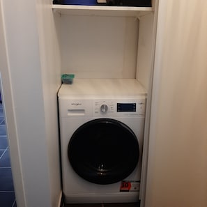 A compact Whirlpool washer and dryer unit in a small utility space. - Patio Arena, classified 2 *, terrace, parking lot, wifi (Bayonne)