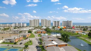 A coastal resort area with high-rise buildings, a marina, and a golf course. - Gulf Terrace Getaway by Avantstay Shared Pool + Tennis Near Henderson Beach + Destin Commons (Destin)