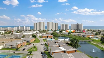 A coastal resort area with high-rise buildings, a marina, and a golf course.