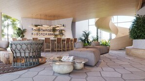 A modern outdoor lounge area with a bar, seating, and plants. - Pipa Island Resort - GAV Resorts (Tibau do Sul)