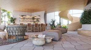 Un espacio lounge moderno al aire libre con barra, asientos y plantas.