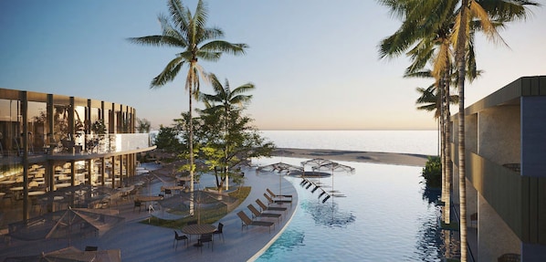 A poolside area with lounge chairs and umbrellas, palm trees, and a view of the sea. - Pipa Island Resort - GAV Resorts (Tibau do Sul)