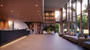 A modern lobby with a reception desk, seating area, and large windows. - Pipa Island Resort - GAV Resorts (Tibau do Sul)