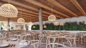 A spacious outdoor dining area with round tables and wicker chairs, featuring a wooden ceiling and hanging wicker lamps. - Pipa Island Resort - GAV Resorts (Tibau do Sul)
