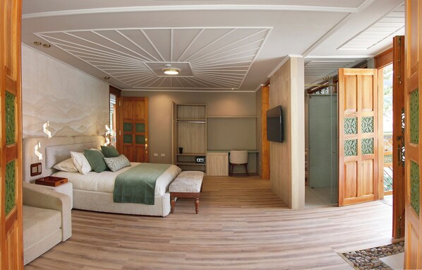 A bedroom with a bed, bedside table, and a TV.
