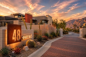 A modern building with a large sign reading '48 @ARENAS' and a paved entrance. - Downtown Modern Palm Springs Oasis | 2 King Suites (Palm Springs)