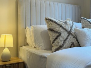 A neatly made bed with white bedding and a fluffy pillow with a zigzag pattern. - Large 3 bed house, 4 TVs, driveway parking. (Newcastle upon Tyne)
