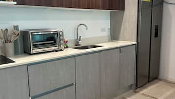 Full-sized fridge, microwave, cookware/dishes/utensils