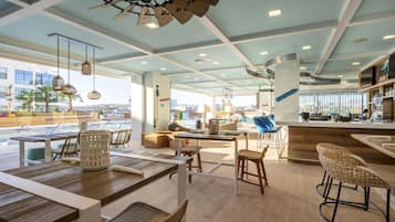 A modern bar area with seating, a pool view, and a bar counter.