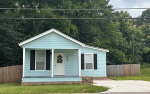 A small, single-story house with a front porch, a mailbox, and a number '6027' on the door. - The Julep House - a 2-bedroom cottage in Beautiful Saint Francisville, LA! (Saint Francisville)